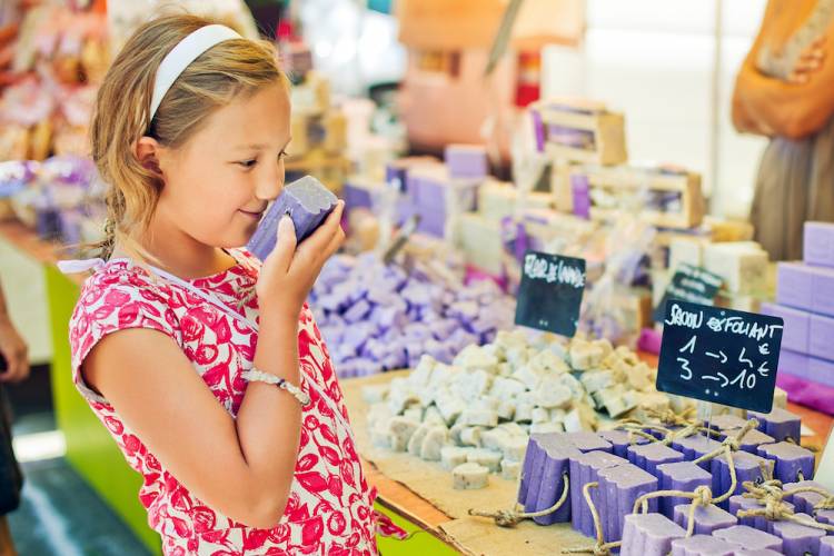 Girl sniffing handmade soap at a craft fair