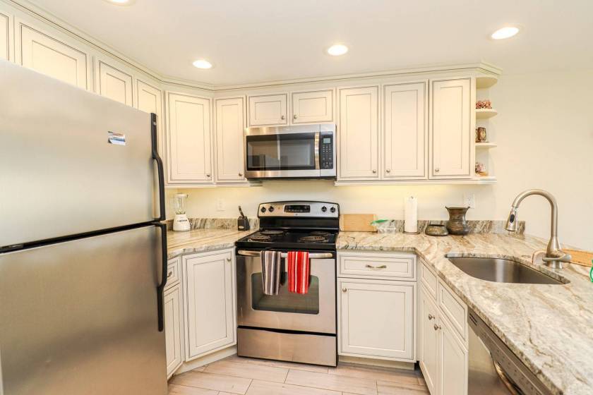 kitchen with white cabinets, stainless steel appliances and granite countertops